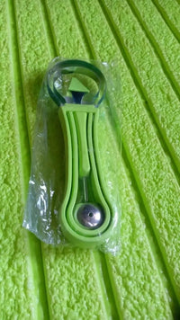 Professional 4 in 1 Watermelon Cutter Stainless Steel green melon baller and slicer set on textured green background.