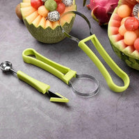 Professional 4 in 1 Watermelon Cutter Stainless Steel with green handles and fruit scoops on gray surface.
