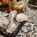 Detailed 3D skull-shaped silicone ice cube tray in a vibrant color, perfect for creating spooky, fun ice cubes for drinks.